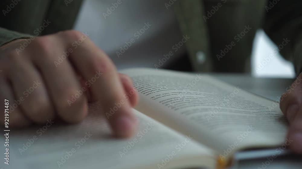 A man reads a book close-up.
A book in the hands of a man A man reads a book close-up.
A book in the hands of a man