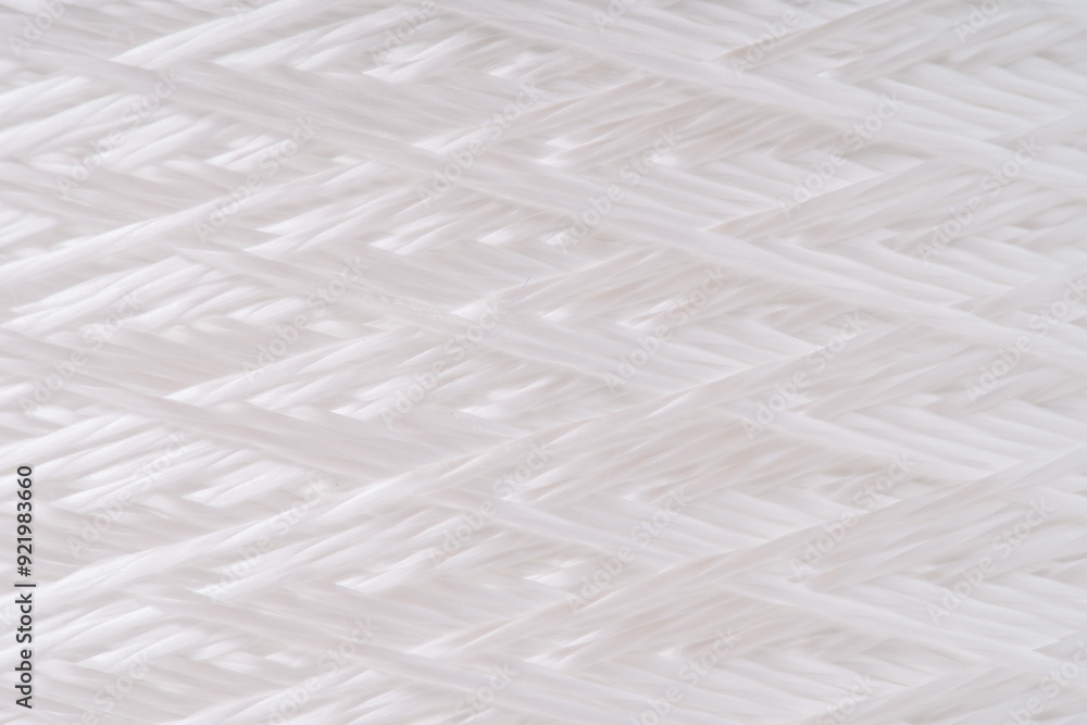 Close-up view of tightly woven fiberglass threads. The intricate pattern showcases the texture and craftsmanship of the material. Close-up view of tightly woven fiberglass threads. The intricate pattern showcases the texture and craftsmanship of the material.
