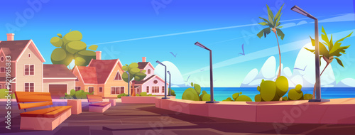 Cozy modern luxury houses on shore of sea or ocean with wooden benches and street light lamps on promenade street with green palm trees and bushes. Suburban city landscape with cottages on waterfront.