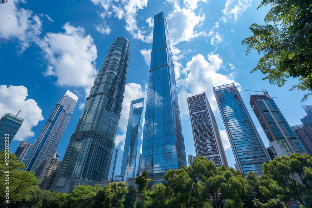 Obraz premium Skyscrapers Viewed from Below with Blue Sky and White Clouds