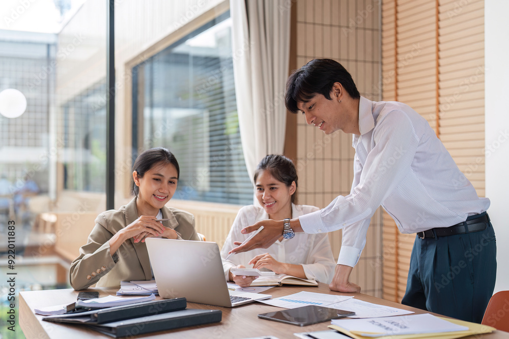 Business Team Collaborating on Work Plans During a Meeting in a Modern Office Setting Business Team Collaborating on Work Plans During a Meeting in a Modern Office Setting