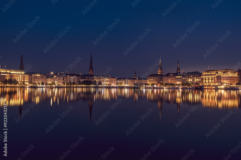 Fototapeta premium The reflection of the city center onto the water at night in Germany. The northern German city at night in Summer
