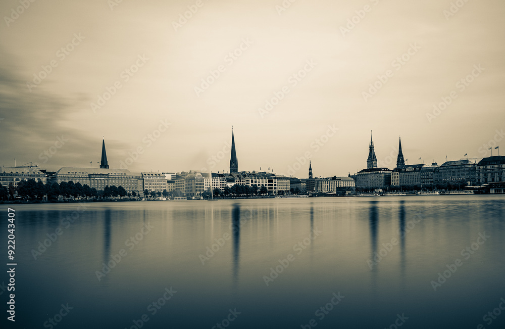 Naklejka premium Reflection of the city onto a lake in Germany with the monochrome photo style near Hamburg, Germany