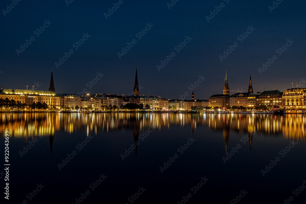 Obraz premium The reflection of the city center onto the water at night in Germany. The northern German city at night in Summer