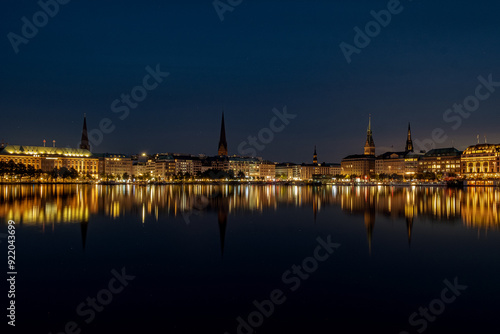 The reflection of the city center onto the water at night in Germany. The northern German city at night in Summer