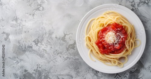 Photo of spaghetti with tomato sauce on a white plate, with a top view banner background leaving space for text or design, placed on a light gray concrete table. A concept food photography stock