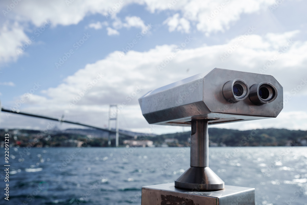 Coin Operated Binocular viewer next to the waterside promenade in Istanbul looking out to the Bay and city. Coin Operated Binocular viewer next to the waterside promenade in Istanbul looking out to the Bay and city.