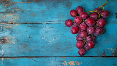  a compelling image of a red grape on an old blue wood table