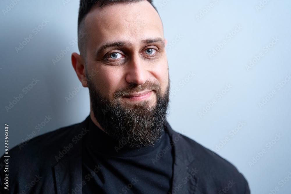 Studio portrait of young handsome man with beard. Studio portrait of young handsome man with beard.