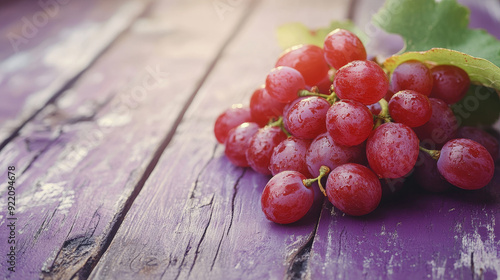  a compelling image of a red grape on an old blue wood table