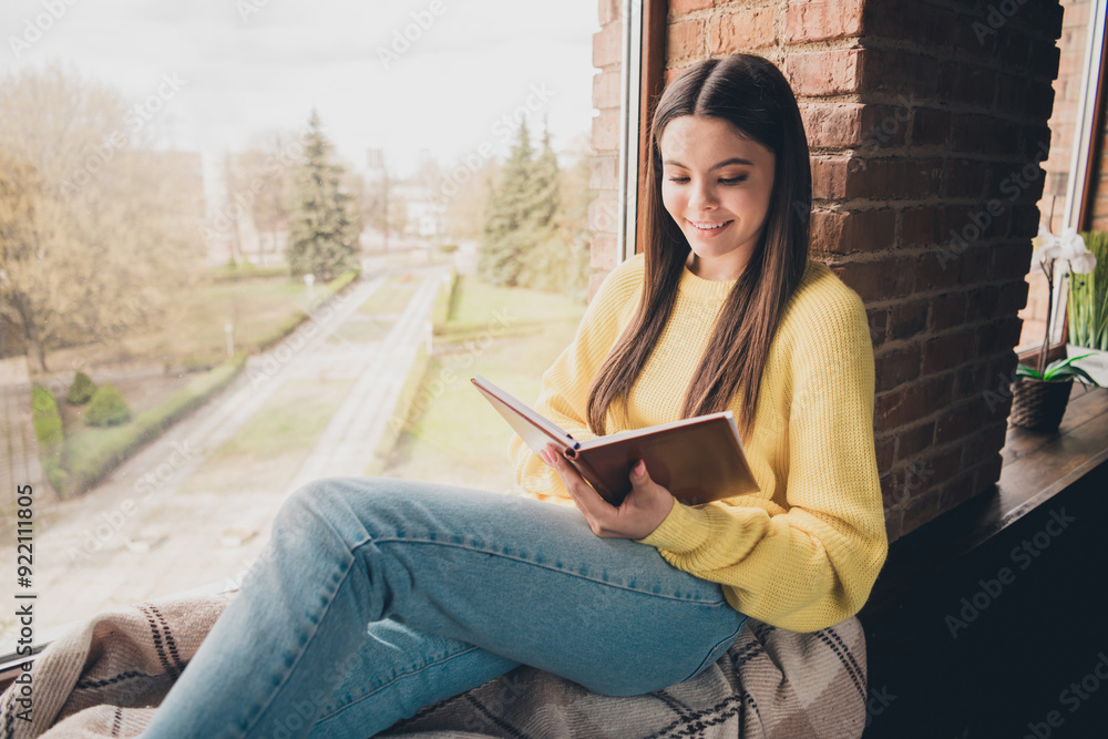Obraz premium Photo portrait of attractive teen woman read book sit windowsill dressed yellow outfit cozy day light home interior living room