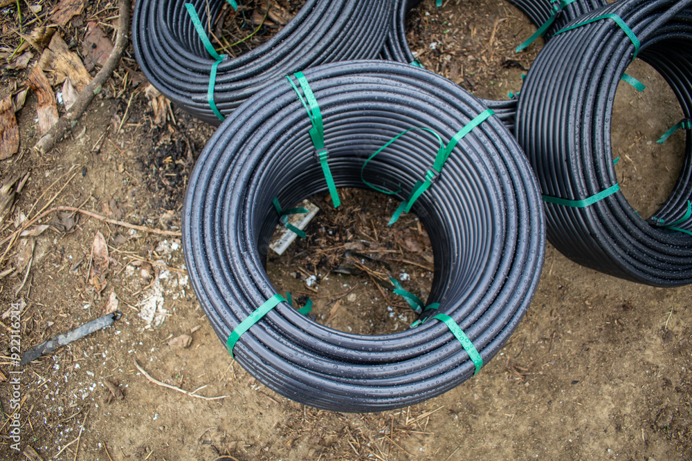 New Irrigation Hose Rolls Stacked in Field – Agricultural Watering Equipment New Irrigation Hose Rolls Stacked in Field – Agricultural Watering Equipment