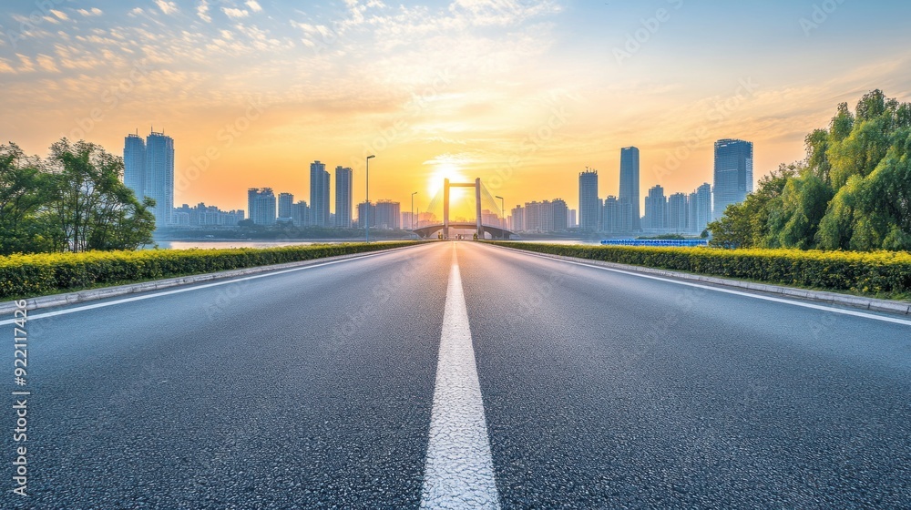 Asphalt Road Leading to City Skyline at Sunset Asphalt Road Leading to City Skyline at Sunset