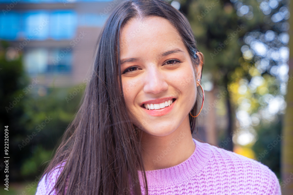 Portrait of a smiling young woman looking at camera outdoors. Portrait of a smiling young woman looking at camera outdoors.