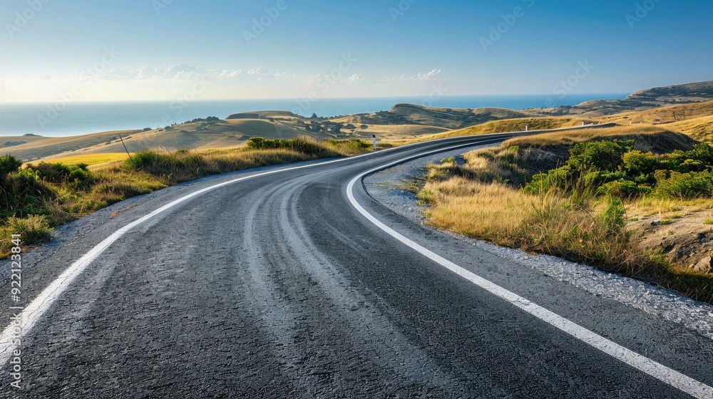 Fototapeta premium A smooth, open road winding through a scenic landscape, representing the journey to success and endless possibilities