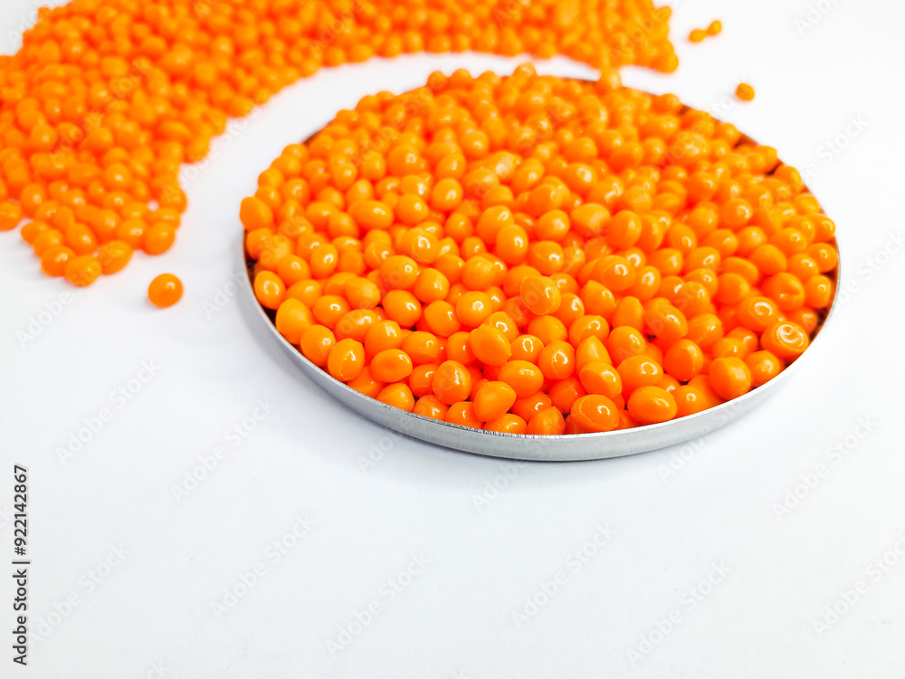 Sheer apricot masterbatch granules on white background. Color pigment carrier polymer in plastic industry Sheer apricot masterbatch granules on white background. Color pigment carrier polymer in plastic industry