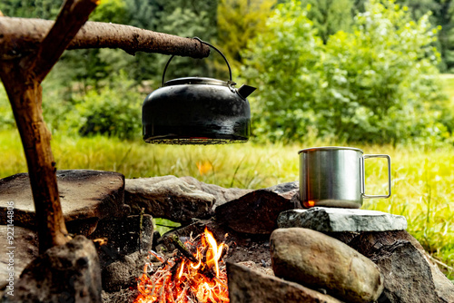 Coffee pot on a campfire during a hike in the mountains. photo