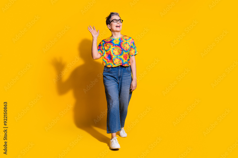Fototapeta premium Photo of adorable lovely woman wear trendy print clothes look empty space isolated on vibrant yellow color background
