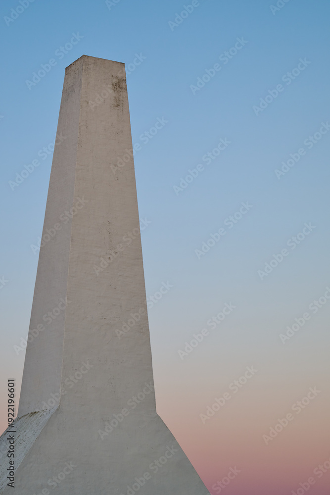 Obraz premium Minimalist Architectural Detail of the chimney of a fish smokery on the Danish island of Bornholm with with Pastel Gradient Sky at Sunset