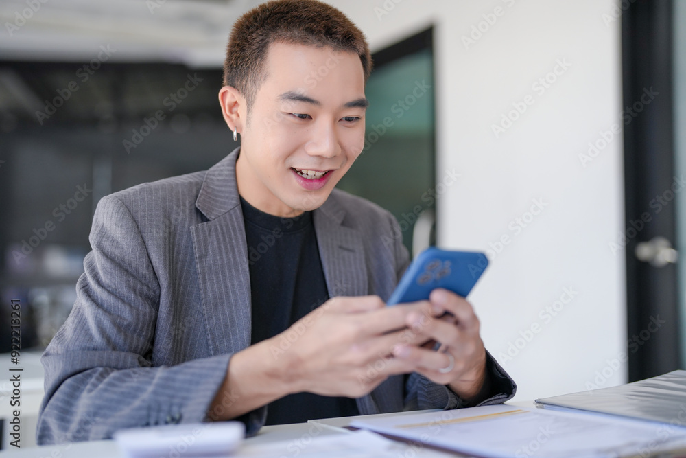 Asian Businessman with Smartphone working mobile devices cell telephone technology e-commerce smartphone business professional investor working new start up project Asian Businessman with Smartphone working mobile devices cell telephone technology e-commerce smartphone business professional investor working new start up project