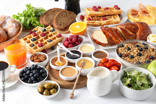 Different meals served for breakfast on white table