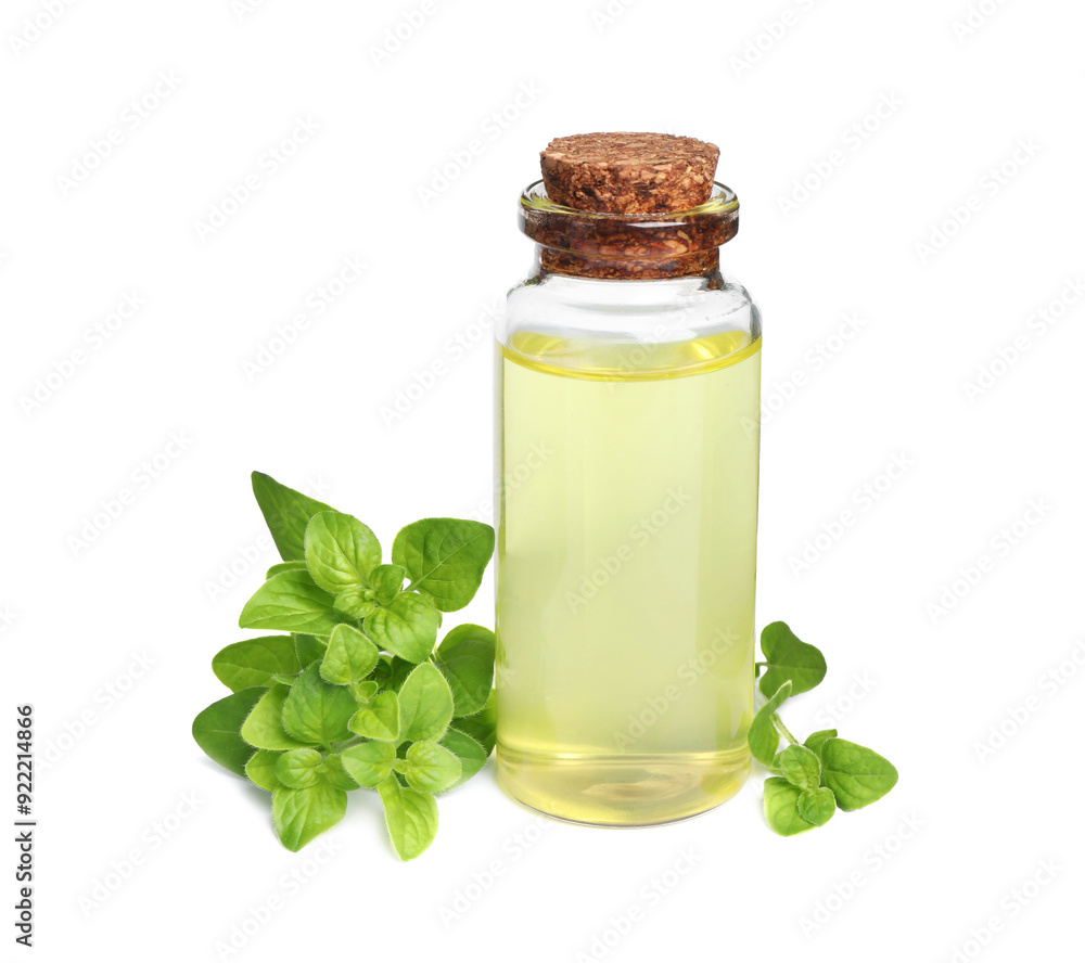 Essential oil in bottle and oregano leaves isolated on white Essential oil in bottle and oregano leaves isolated on white