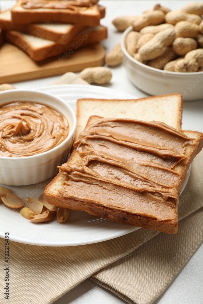 Delicious sandwich with peanut butter and fresh nuts on table, closeup Delicious sandwich with peanut butter and fresh nuts on table, closeup