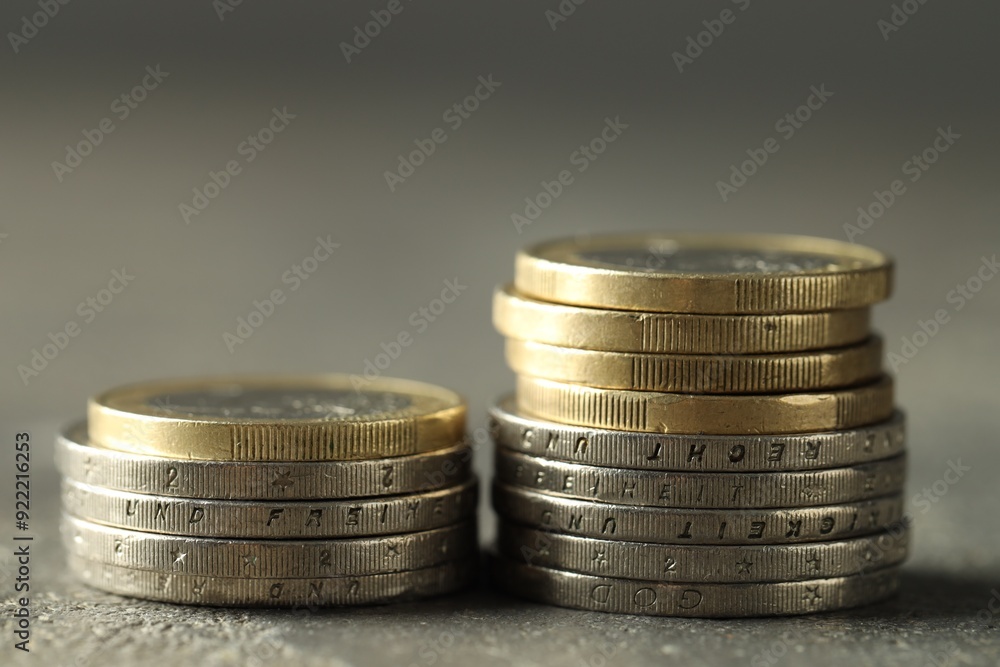 Stacked euro coins on grey table, closeup Stacked euro coins on grey table, closeup