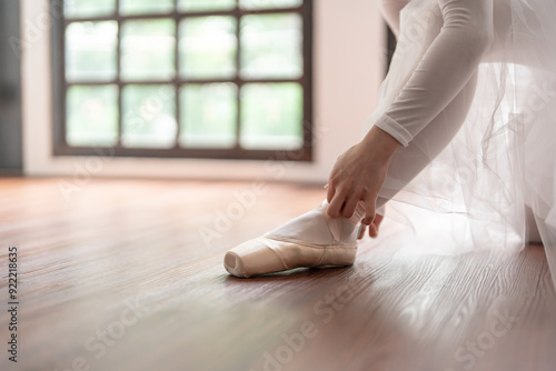 Wallpaper Mural Ballerina in ballet shoes. Asian girl tying ribbons of toe shoes. ballet dancer preparing and wearing ballet shoes in dance studio prepares for a rehearsal. Torontodigital.ca
