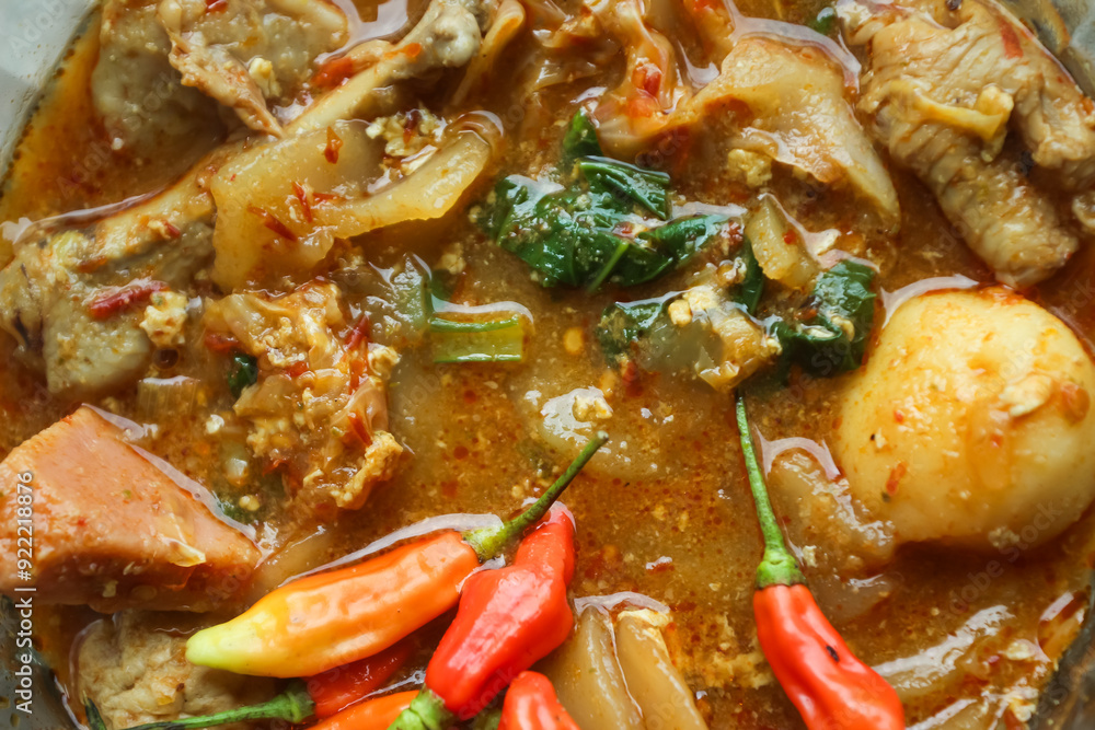Seblak is a typical Indonesian dish with a savory and spicy taste. Made from wet crackers cooked with vegetables, sausage, eggs. a bowl of seblak on a wooden table. Seblak is a typical Indonesian dish with a savory and spicy taste. Made from wet crackers cooked with vegetables, sausage, eggs. a bowl of seblak on a wooden table.
