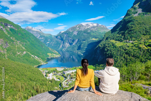 Tableau sur toile Norwegian Fjord Views From a Mountaintop, couple at Geiranger Fjord Norway