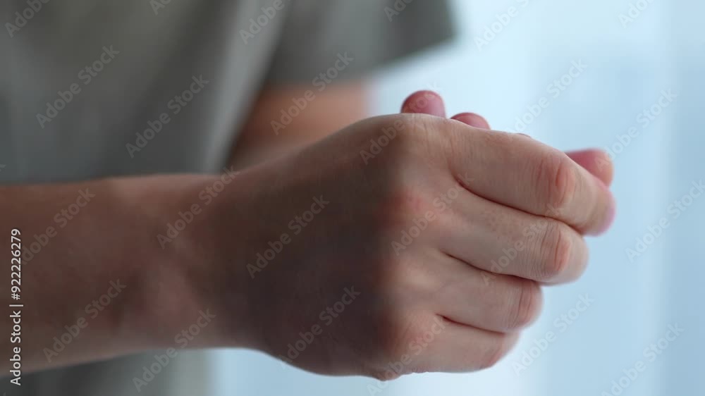 man applies the cream and carefully smears it on his hands man applies the cream and carefully smears it on his hands