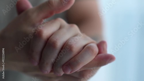 man has dry skin on his hands and he applies the cream and gently smears the hand cream on his hands