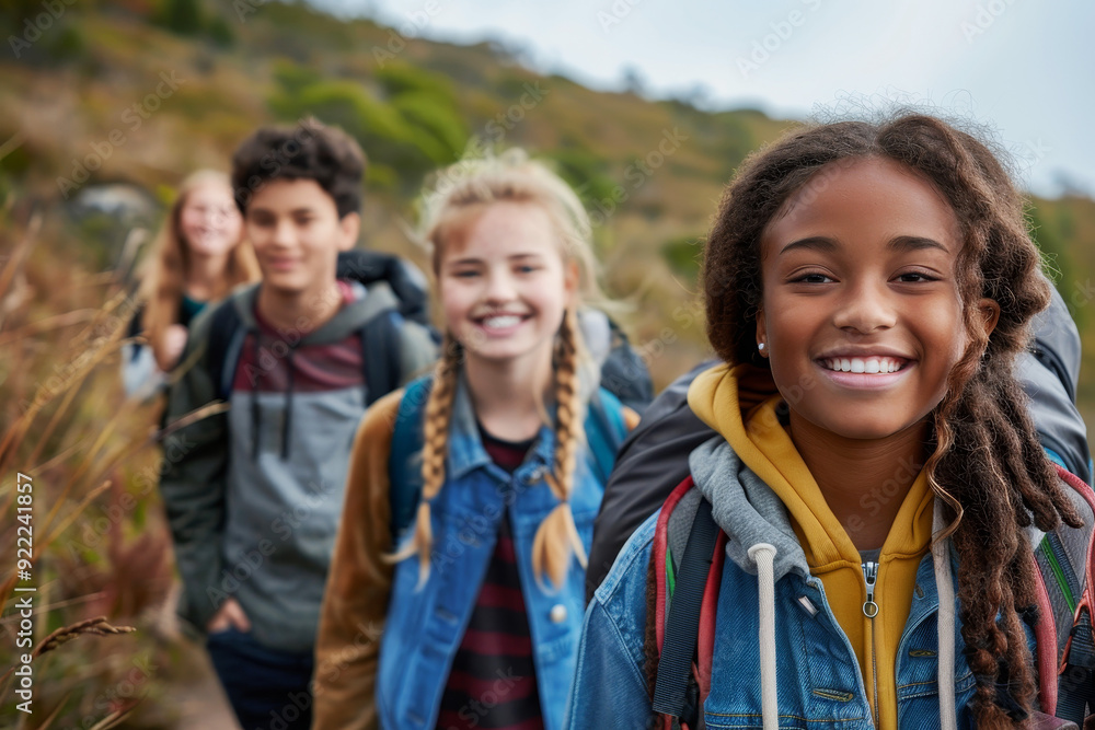 Diverse group of happy teenagers hiking and enjoying nature together on a sunny day Diverse group of happy teenagers hiking and enjoying nature together on a sunny day