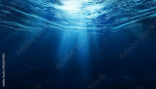 Deep blue undersea with sunlight ray through over surface ripple wave background. Dark scene beneath blue sun beam. Abstract marine and aquatic. 3D illustration