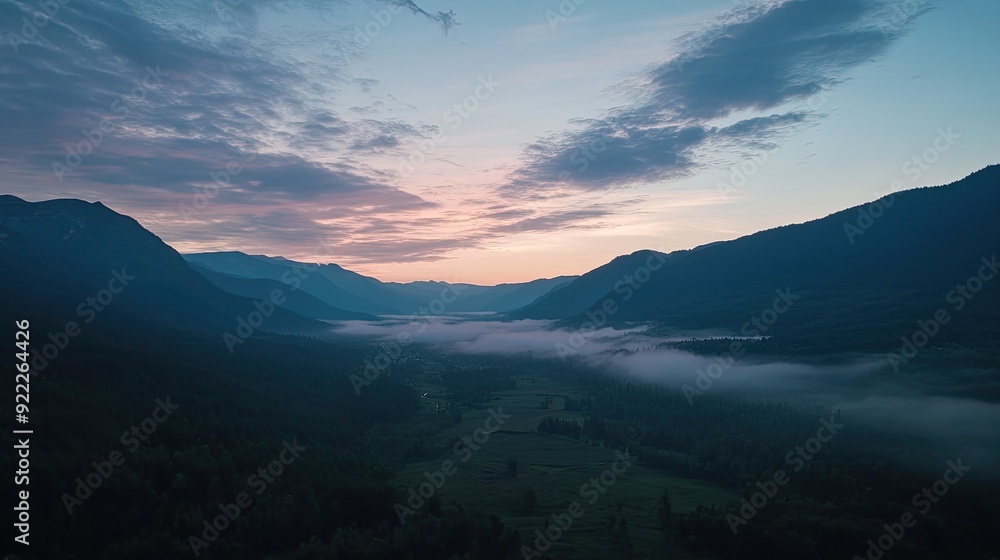 Obraz premium Overhead view of a mountain valley at dawn, with ample space for adding text in the sky