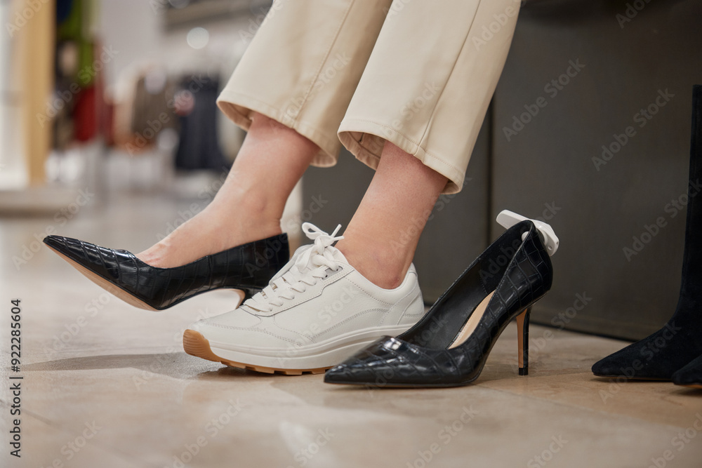 Shopping at footwear showroom concept, shot with female legs view Shopping at footwear showroom concept, shot with female legs view