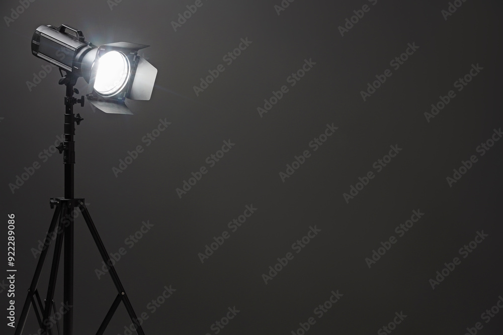 Fototapeta premium Dark photo background and professional lighting equipment in studio, space for text