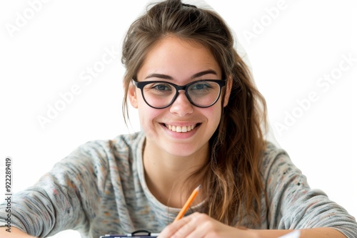 Confident Student's Focus: A young woman beams with determination, engrossed in her studies. Her glasses, pencil poised, and radiant smile convey the joy of learning. 