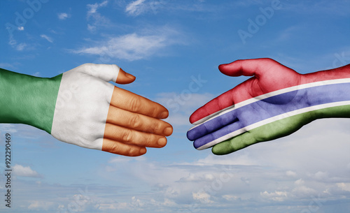 Gambia and Ireland country handshaking with flags, consensus concept international co-operation illustration