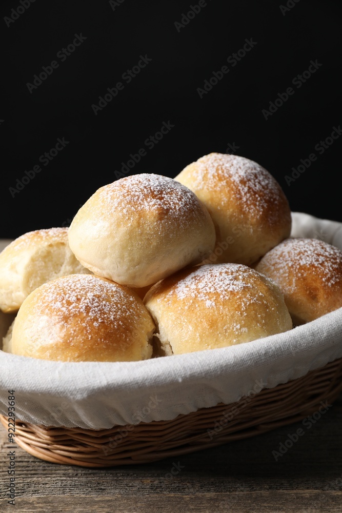 Delicious dough balls in basket on wooden table, closeup Delicious dough balls in basket on wooden table, closeup