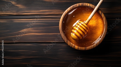 Organic Luxury: Pure Manuka Honey with Honey Dipper on Dark Wooden Surface photo