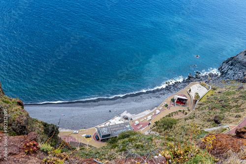 Cristo Rei. Jesus monument on top of a cliff overlooking the Atlantic Ocean and a cable car leading down to the beach on the island of Madeira