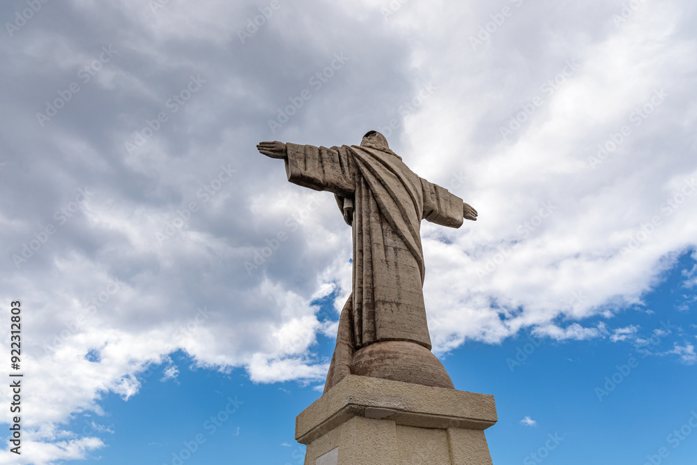 Cristo Rei. Jesus monument on top of a cliff overlooking the Atlantic Ocean and a cable car leading down to the beach on the island of Madeira