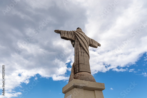 Cristo Rei. Jesus monument on top of a cliff overlooking the Atlantic Ocean and a cable car leading down to the beach on the island of Madeira