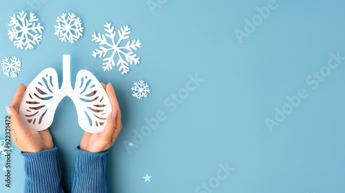 Hands hold a paper silhouette of lungs on a light blue background, symbolizing the fight against smoking on World No Tobacco Day photo