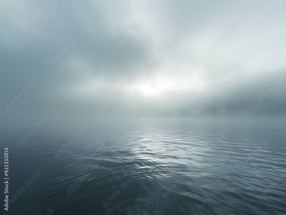 Obraz premium Foggy sunrise over calm water in a serene landscape