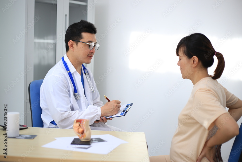 Fototapeta premium Male doctor with experience examining young pregnant women