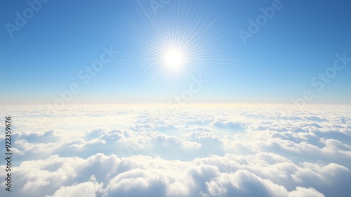 The sun illuminates a vibrant blue sky, casting light over a blanket of fluffy white clouds below.