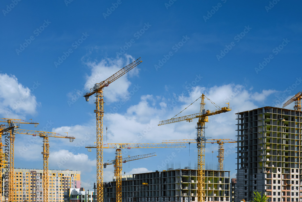 Many high-rise cranes against the backdrop of a construction buildings. Many high-rise cranes against the backdrop of a construction buildings.